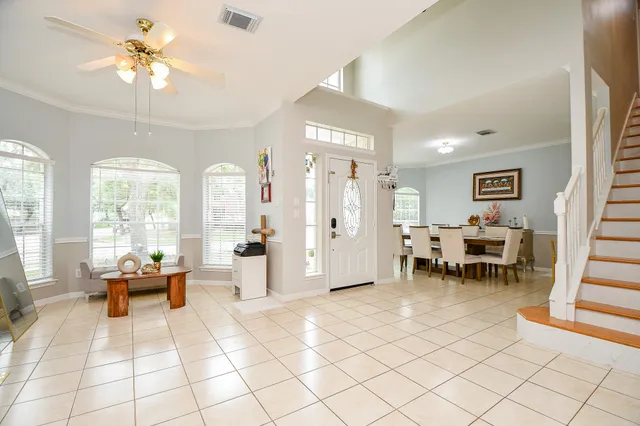 a living room with furniture and a dining table with view of living room