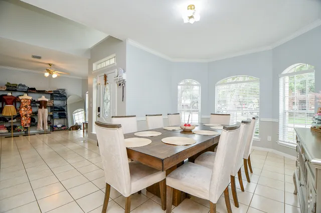 a view of a dining room with furniture and a large window