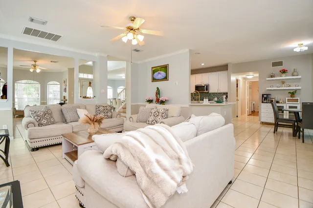 a living room with furniture and a chandelier