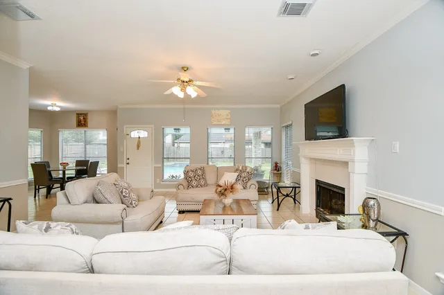 a living room with furniture fireplace and a flat screen tv