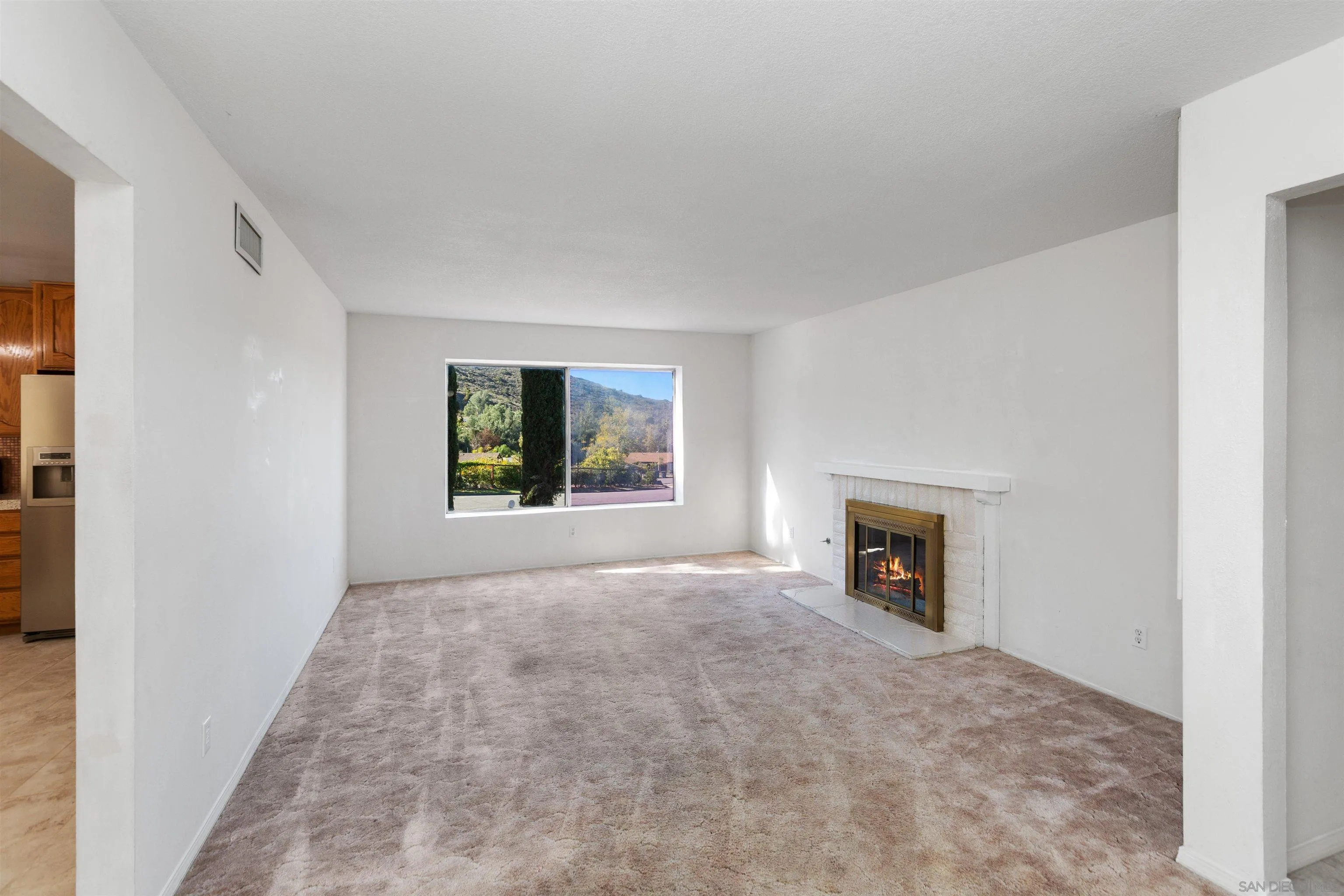 14537 Range Park Place Poway, CA 92064 - Photo 17 of 46 an empty room with windows and fireplace