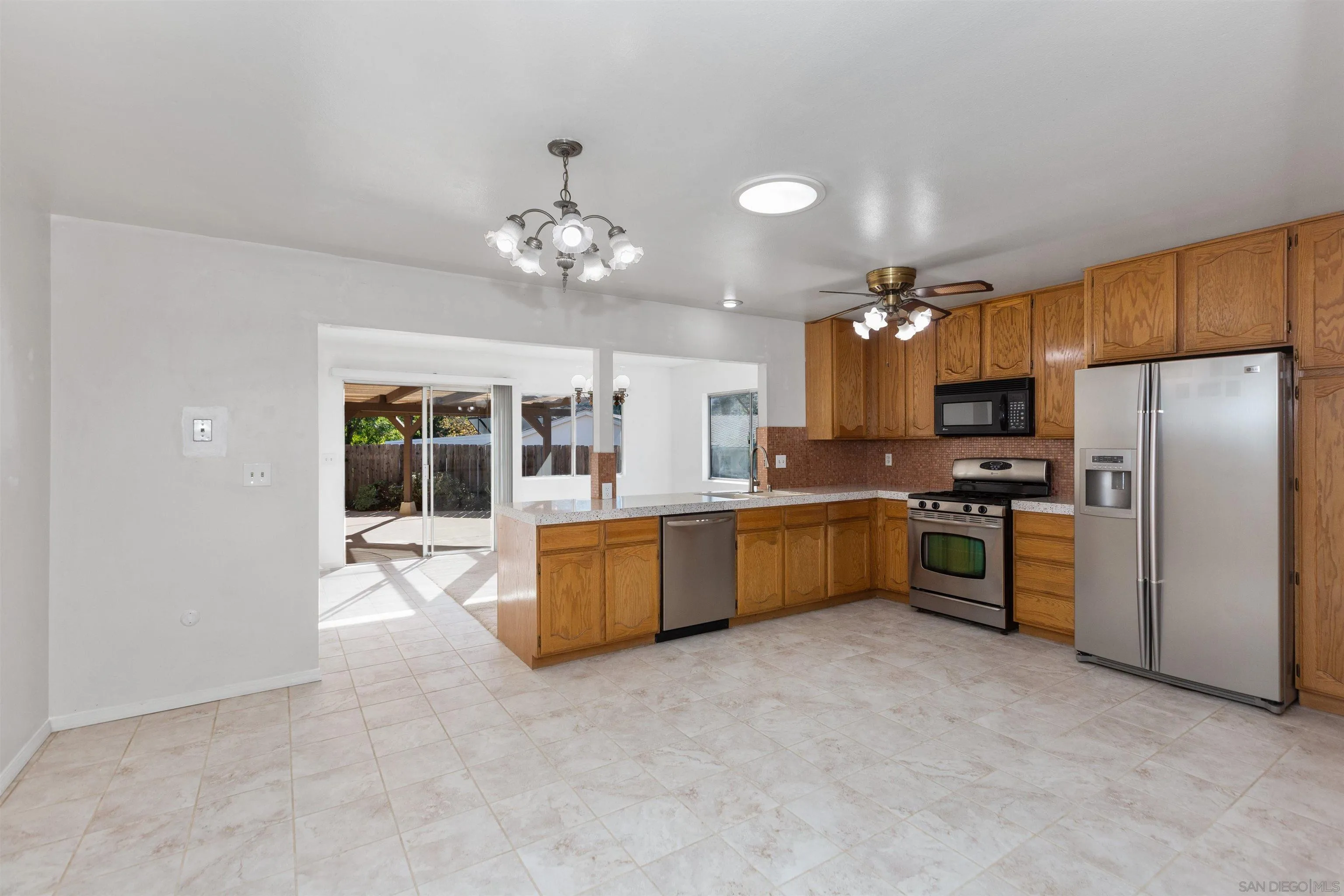 14537 Range Park Place Poway, CA 92064 - Photo 18 of 46 a large kitchen with cabinets and stainless steel appliances