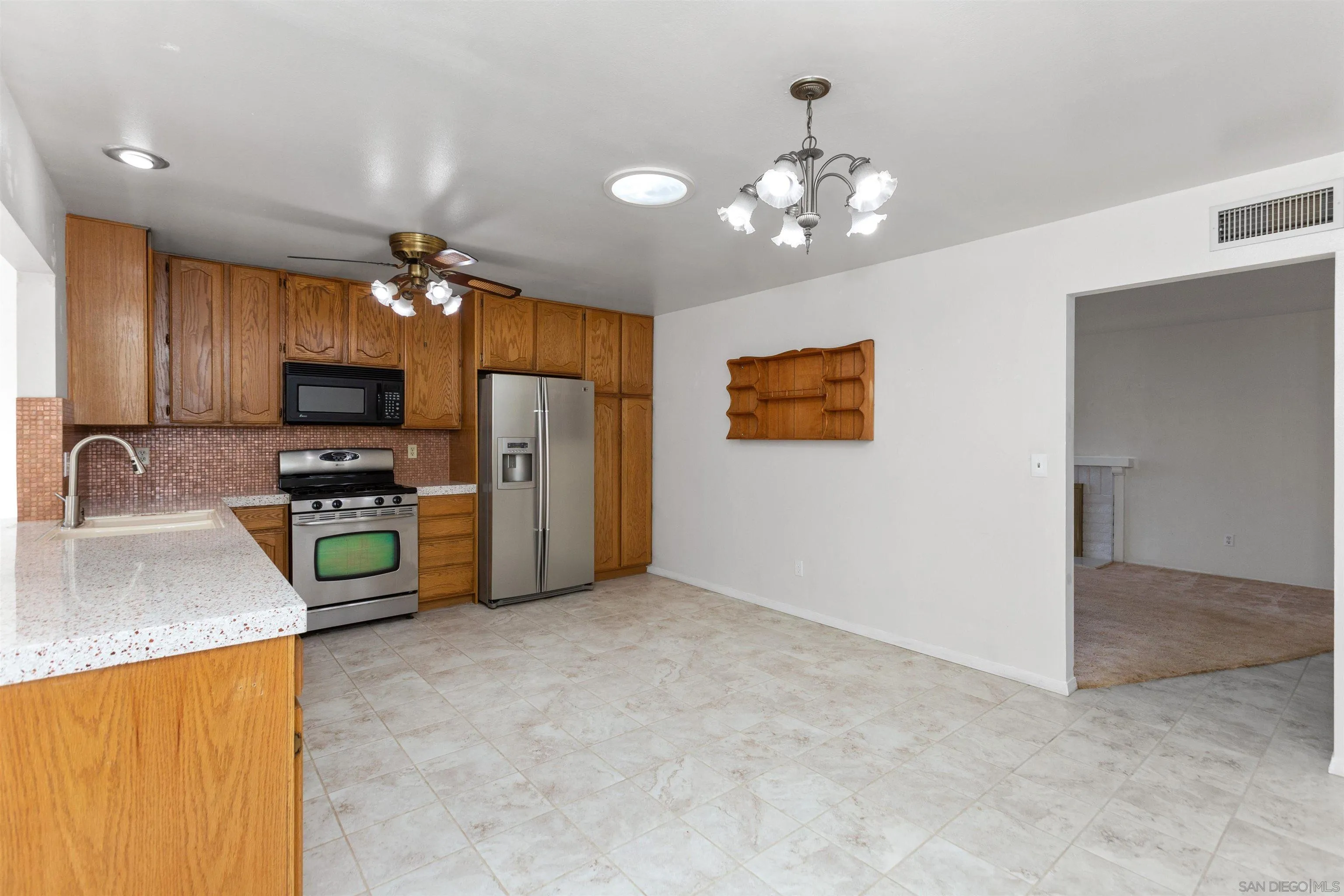 14537 Range Park Place Poway, CA 92064 - Photo 20 of 46 a kitchen with refrigerator and microwave