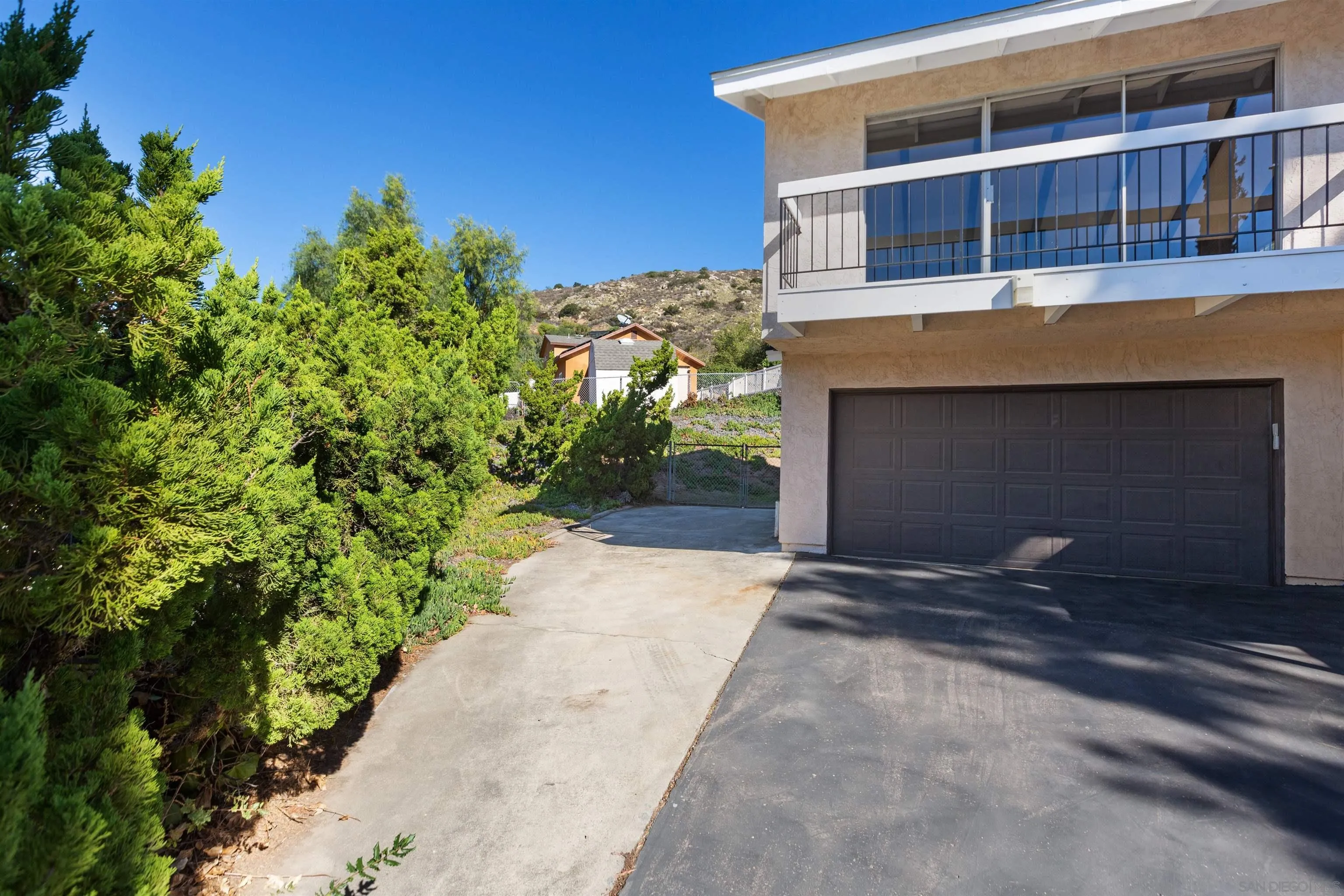 14537 Range Park Place Poway, CA 92064 - Photo 9 of 46 a front view of a house with a yard and garage