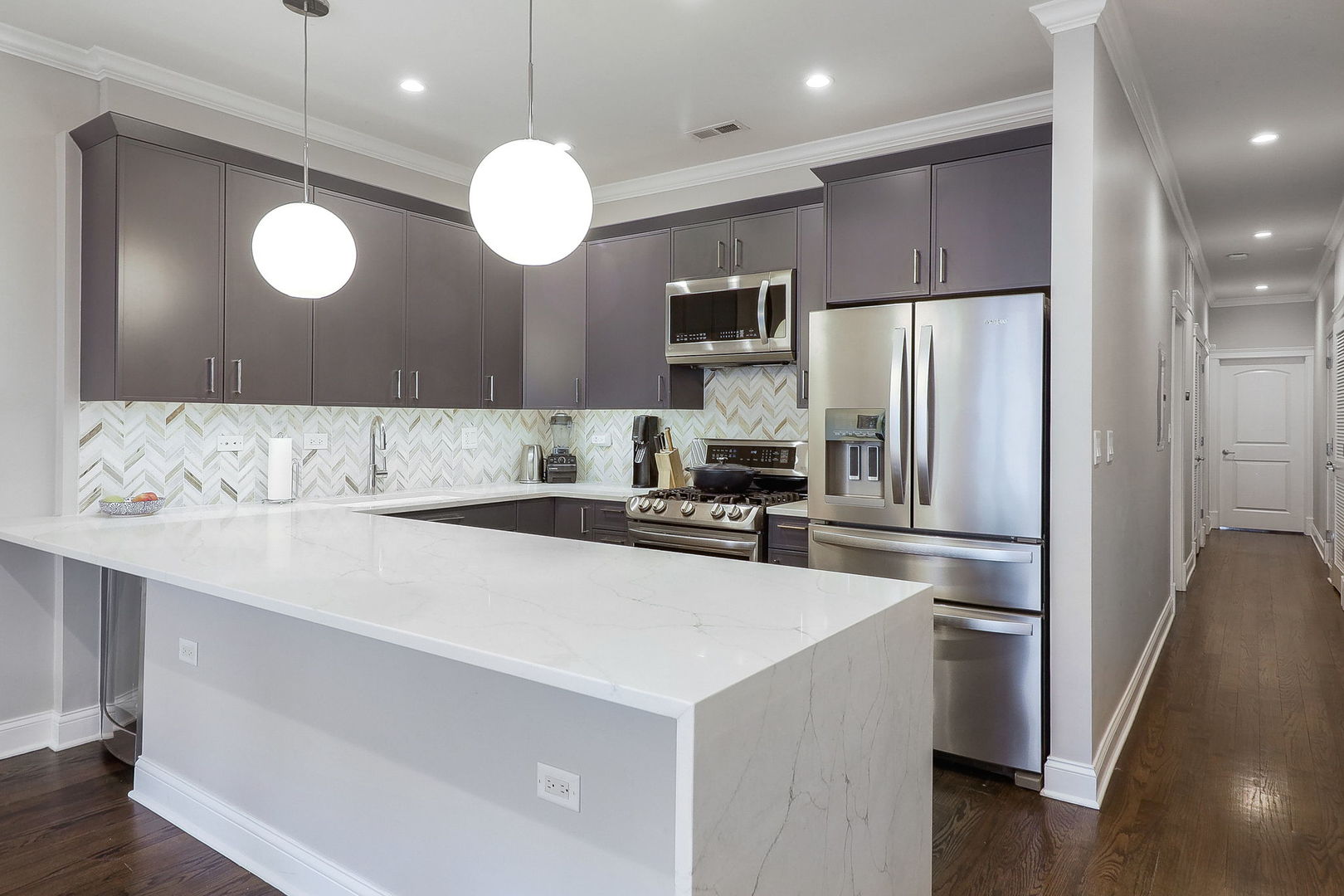 39 North Morgan Street, Unit 3 Chicago, IL 60607 - Photo 5 of 18 a kitchen with a refrigerator a sink cabinets and wooden floor