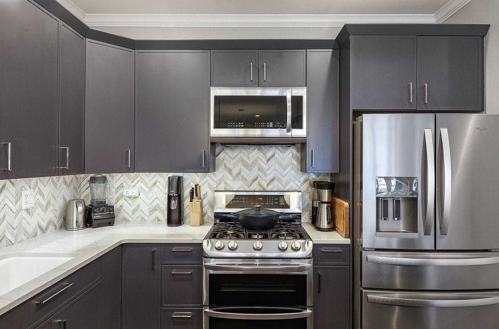 39 North Morgan Street, Unit 3 Chicago, IL 60607 - Photo 7 of 18 a kitchen with stainless steel appliances granite countertop a stove a microwave and a refrigerator