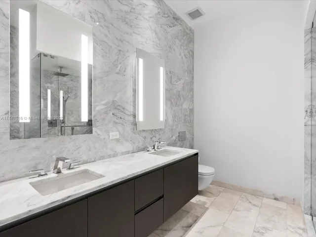 a bathroom with a double vanity sink and mirror