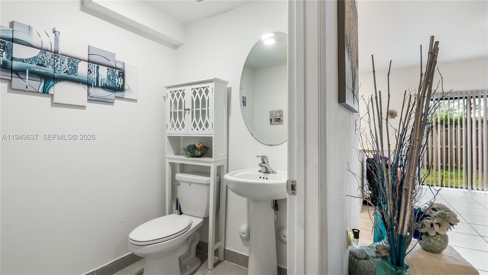 13410 Southwest 287th Terrace Homestead, FL 33033 - Photo 11 of 32 a bathroom with a toilet a sink and a mirror