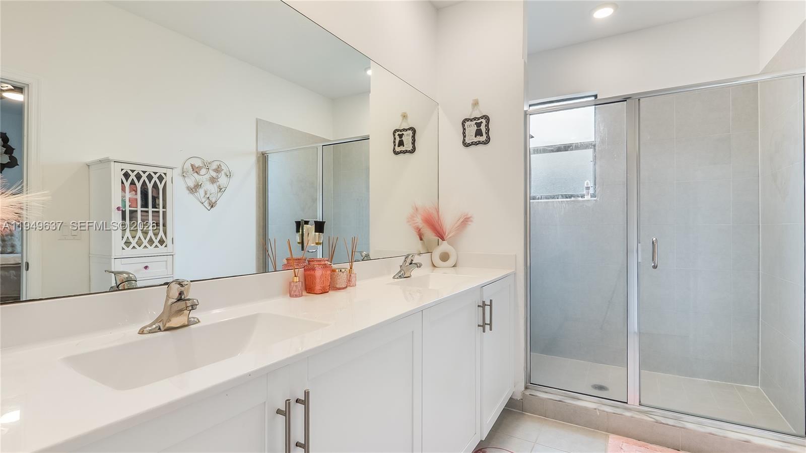 13410 Southwest 287th Terrace Homestead, FL 33033 - Photo 20 of 32 a bathroom with a double vanity sink mirror and shower