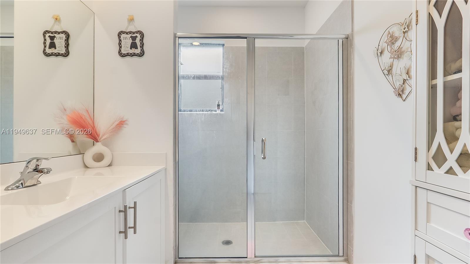 13410 Southwest 287th Terrace Homestead, FL 33033 - Photo 21 of 32 a bathroom with a shower sink and mirror