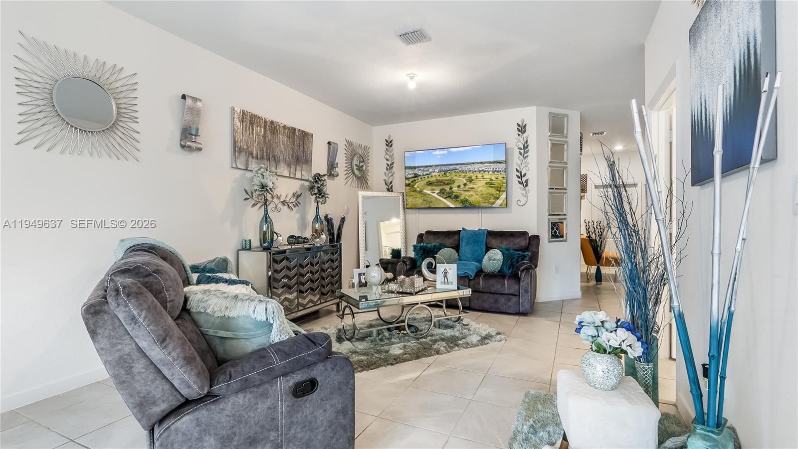 13410 Southwest 287th Terrace Homestead, FL 33033 - Photo 9 of 32 a living room with fireplace furniture and a flat screen tv