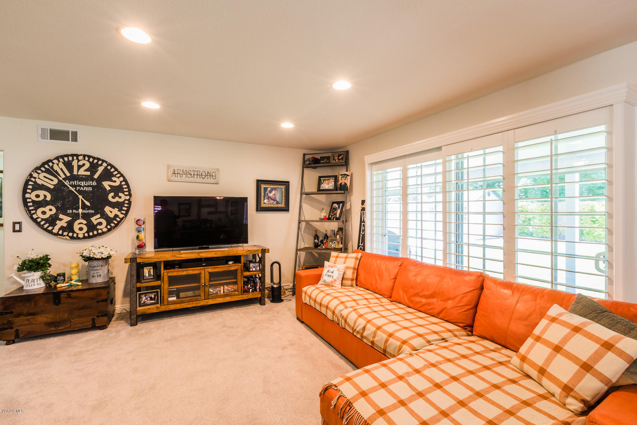 660 Appleton Road Simi Valley, CA 93065 - Photo 12 of 47 a living room with furniture a flat screen tv and a large window