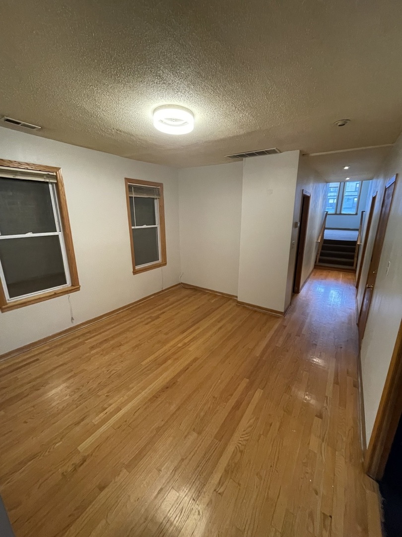 1834 South Racine Avenue Chicago, IL 60608 - Photo 3 of 36 a view of empty room with wooden floor