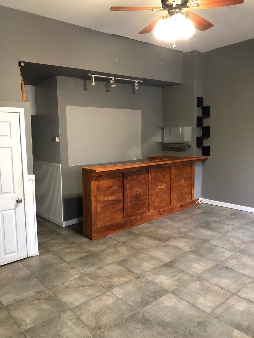 1834 South Racine Avenue Chicago, IL 60608 - Photo 6 of 36 an empty room with a fireplace and cabinet