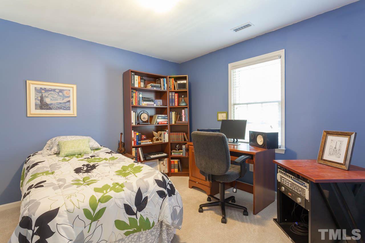 5509 Banwell Place Raleigh, NC 27613 - Photo 13 of 17 a bedroom with a bed and a window