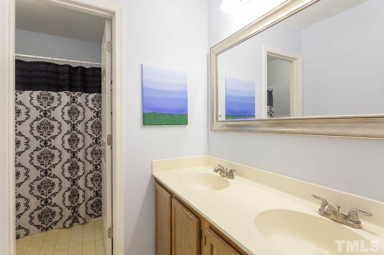 5509 Banwell Place Raleigh, NC 27613 - Photo 17 of 17 a bathroom with a sink and a mirror