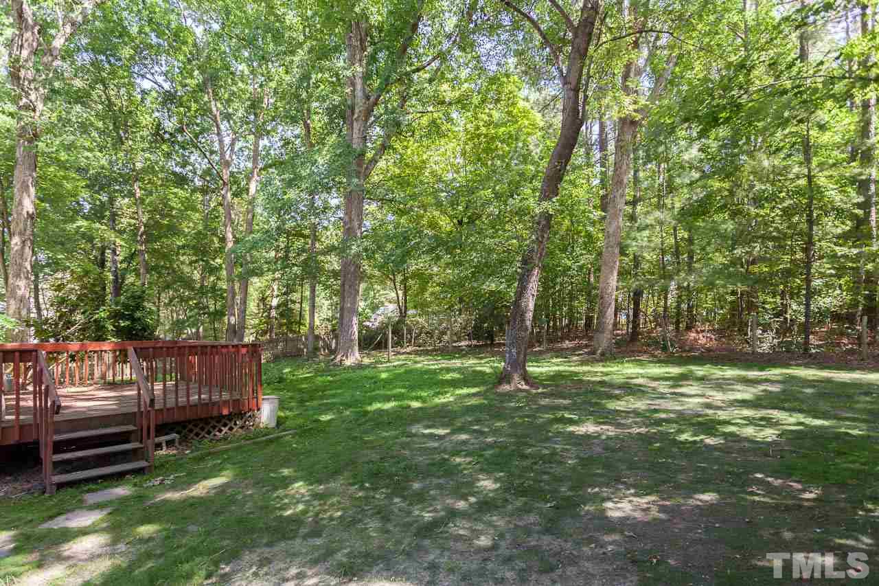 5509 Banwell Place Raleigh, NC 27613 - Photo 5 of 17 a view of a backyard with wooden fence and a trees