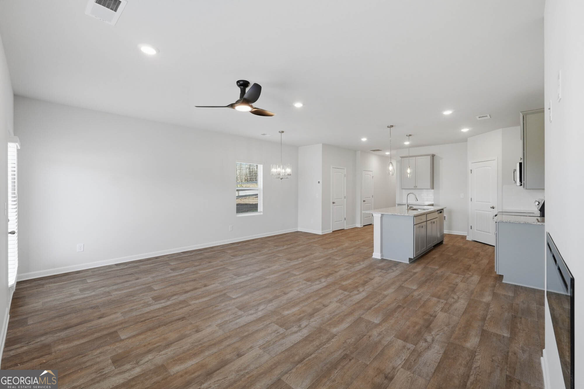 5284 Magnolia Grove Way Gainesville, GA 30504 - Photo 20 of 31 a view of a big room with wooden floor and windows