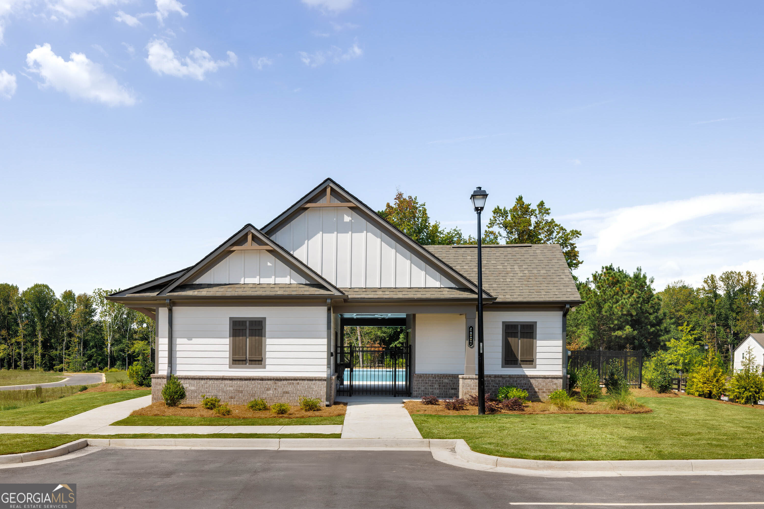 5284 Magnolia Grove Way Gainesville, GA 30504 - Photo 29 of 31 a front view of a house with a yard and garage