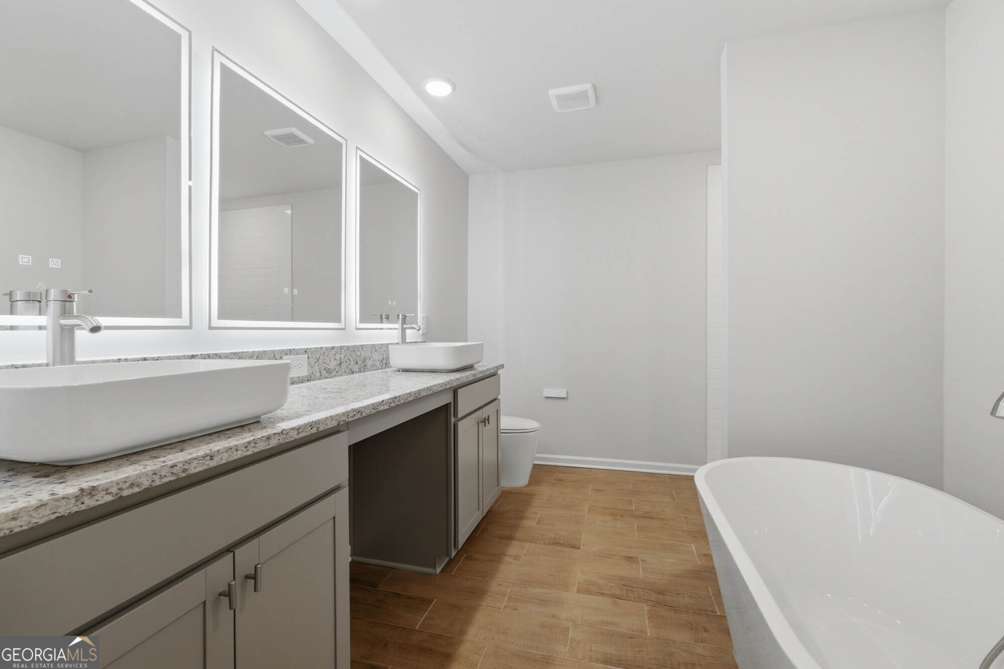 5284 Magnolia Grove Way Gainesville, GA 30504 - Photo 5 of 31 a bathroom with a granite countertop sink and a bathtub
