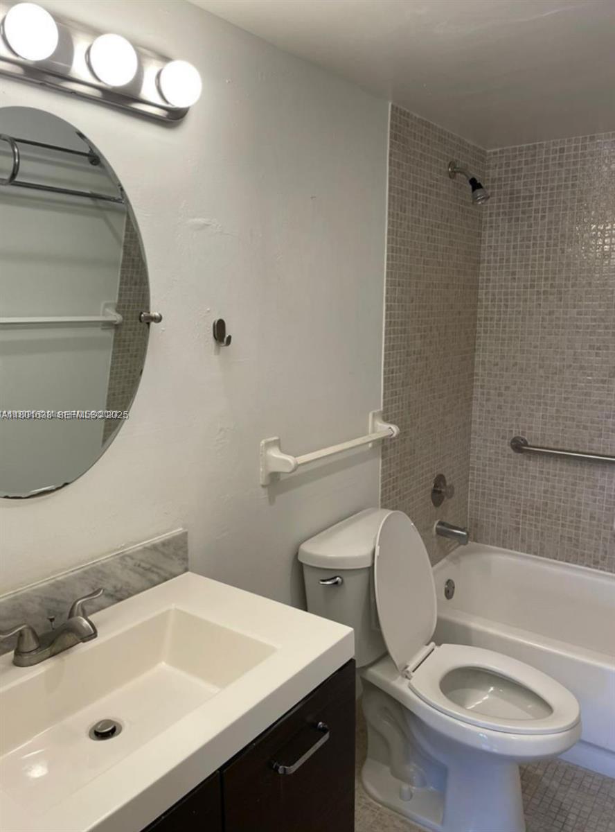 4164 Inverrary Drive, Unit 301 Lauderhill, FL 33319 - Photo 11 of 19 a bathroom with a sink a toilet and shower