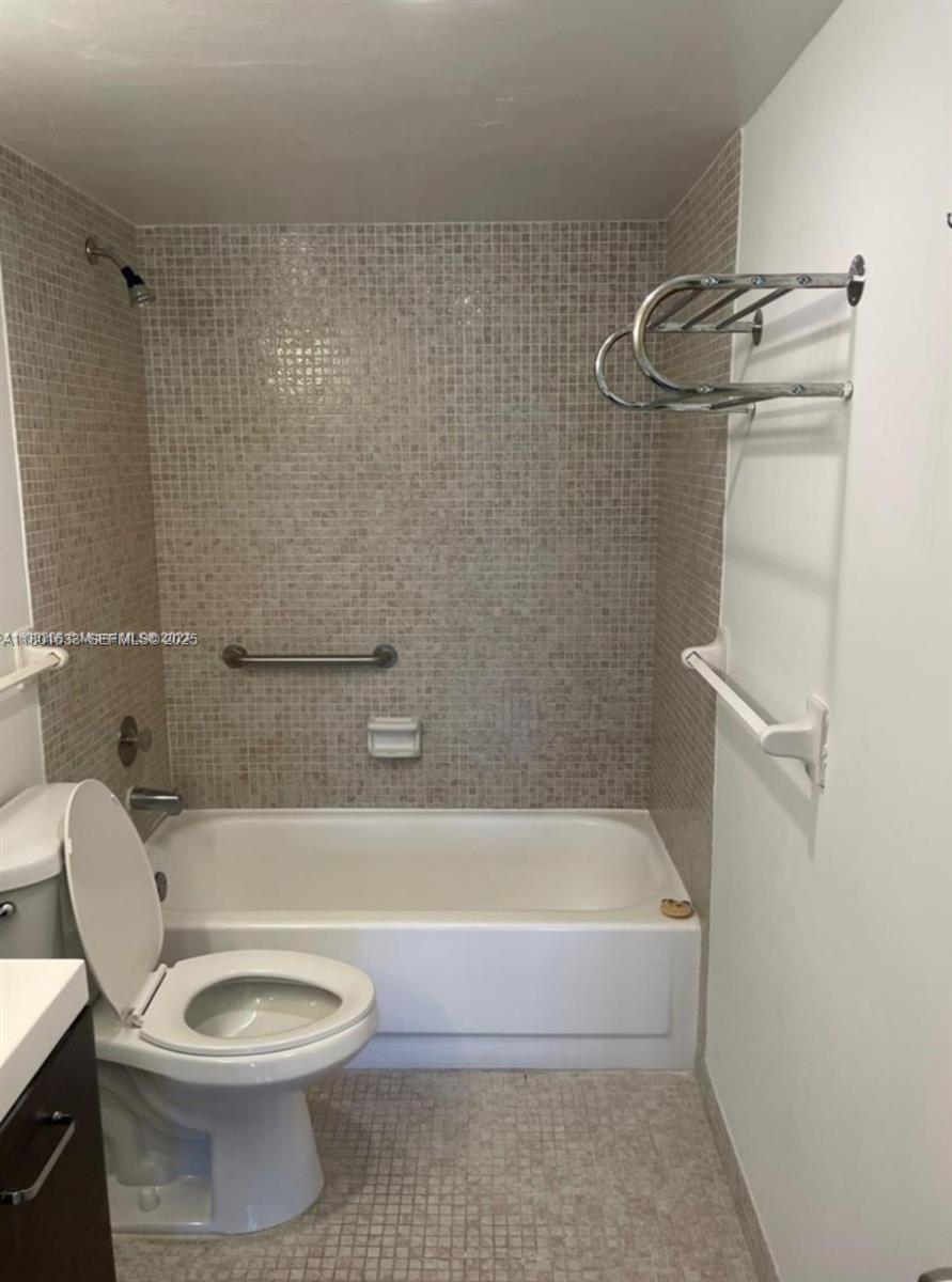 4164 Inverrary Drive, Unit 301 Lauderhill, FL 33319 - Photo 12 of 19 a bathroom with a toilet and a bath tub