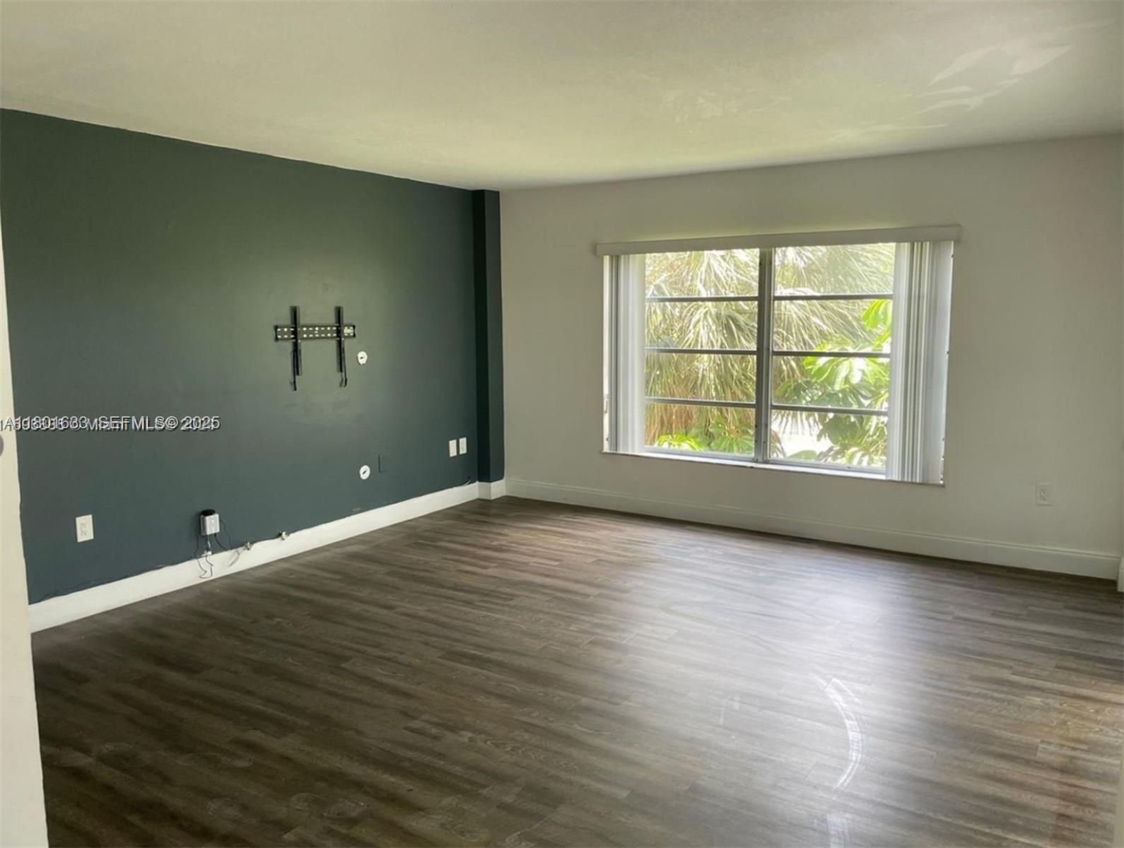 4164 Inverrary Drive, Unit 301 Lauderhill, FL 33319 - Photo 4 of 19 an empty room with wooden floor and windows