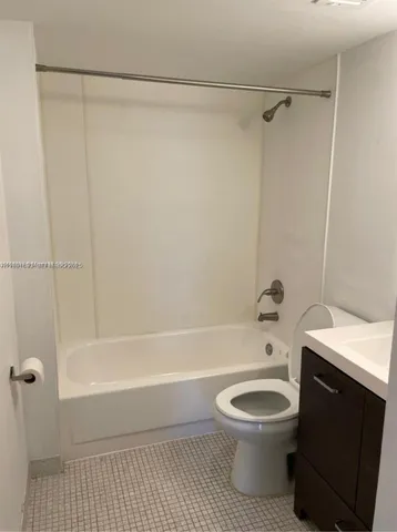 a bathroom with a toilet and a bathtub