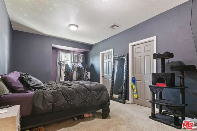 a bedroom with a bed and a desk