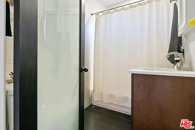 a bathroom with a shower and a sink