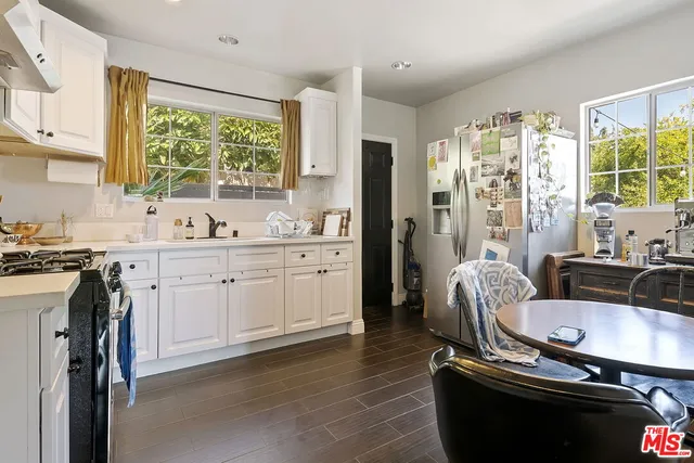 a kitchen with a sink appliances and cabinets