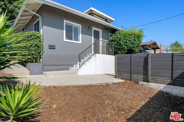a house with a tree in the background