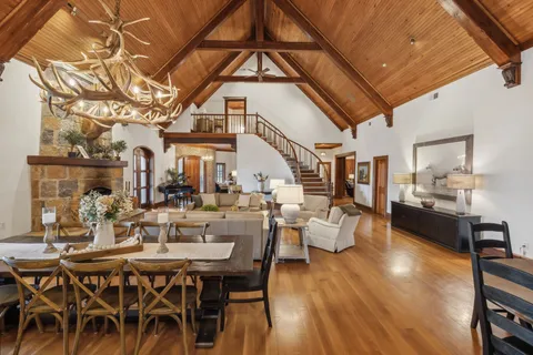a view of a dining room with furniture wooden floor and a chandelier