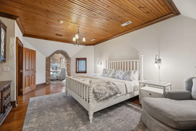 a bedroom with a bed couch and a flat screen tv