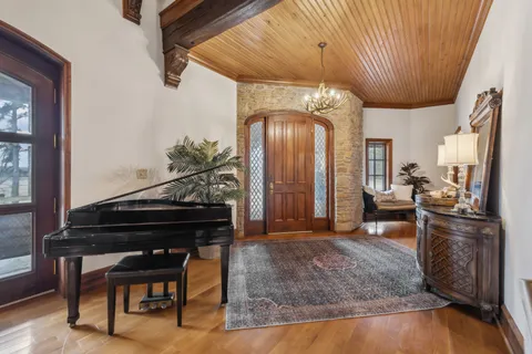 a living room with fireplace furniture and a wooden floor