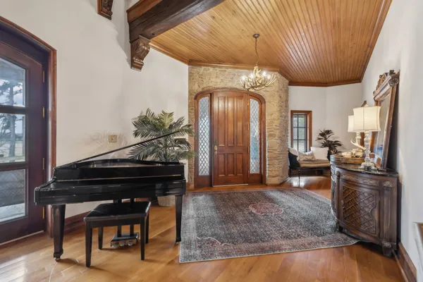 a living room with fireplace furniture and a wooden floor