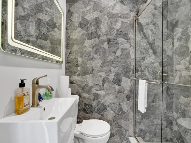 a bathroom with a toilet sink and shower