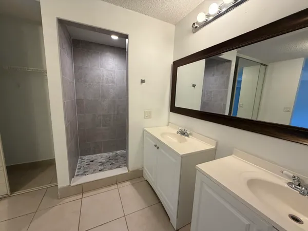 a bathroom with a sink a toilet and mirror