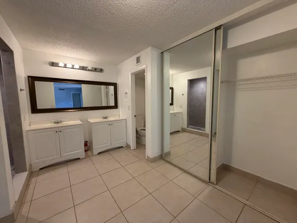 a bathroom with a sink a toilet and mirror