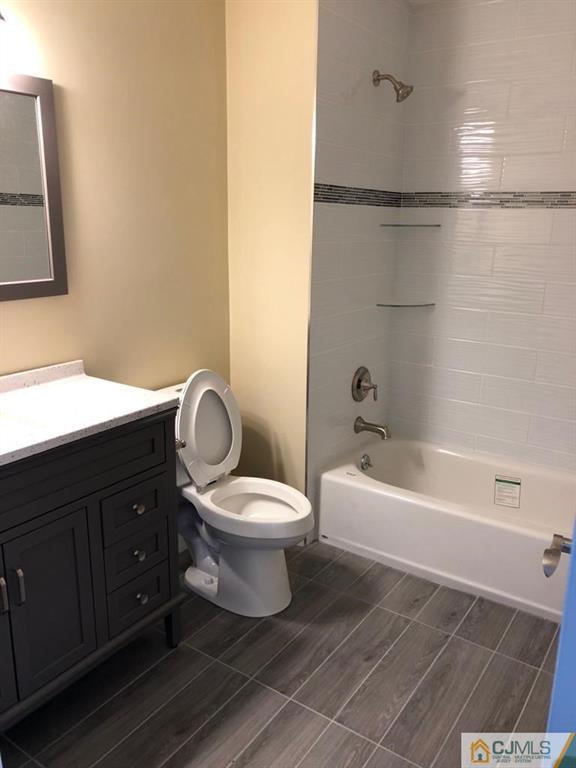 42 Crescent Road Edison, NJ 08817 - Photo 12 of 20 a bathroom with a toilet a sink and a bathtub