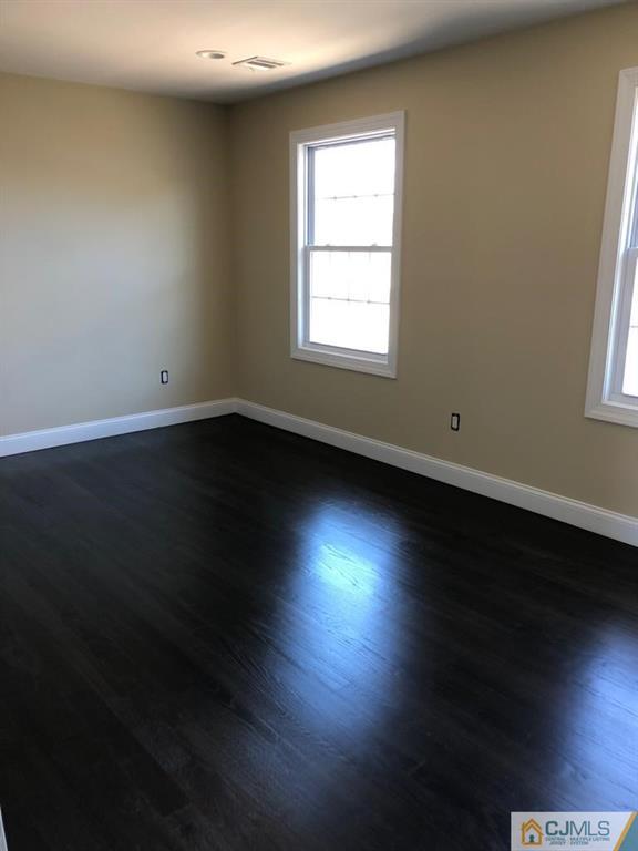 42 Crescent Road Edison, NJ 08817 - Photo 15 of 20 an empty room with wooden floor and windows