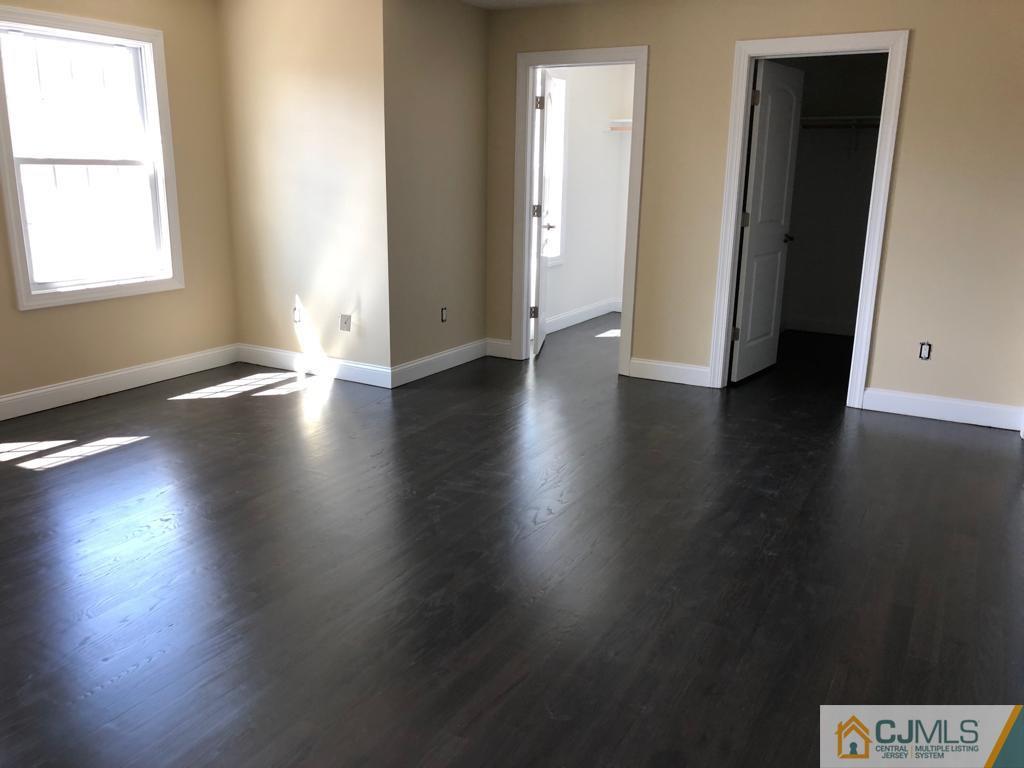 42 Crescent Road Edison, NJ 08817 - Photo 16 of 20 an empty room with wooden floor and windows