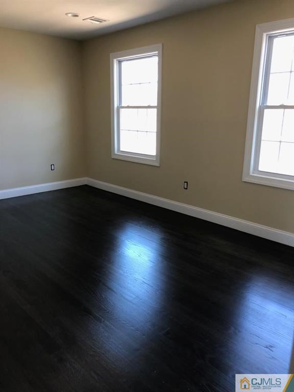 42 Crescent Road Edison, NJ 08817 - Photo 17 of 20 an empty room with wooden floor and windows
