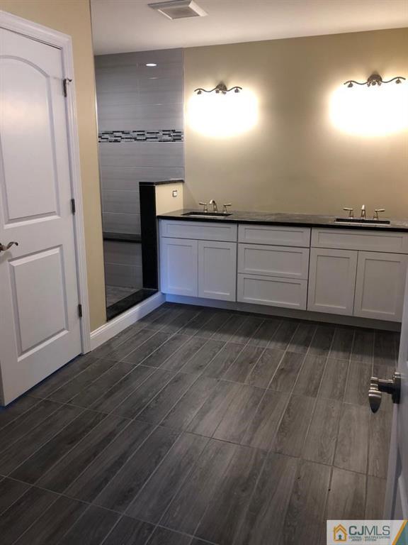 42 Crescent Road Edison, NJ 08817 - Photo 5 of 20 a view of a kitchen with cabinets and wooden floor