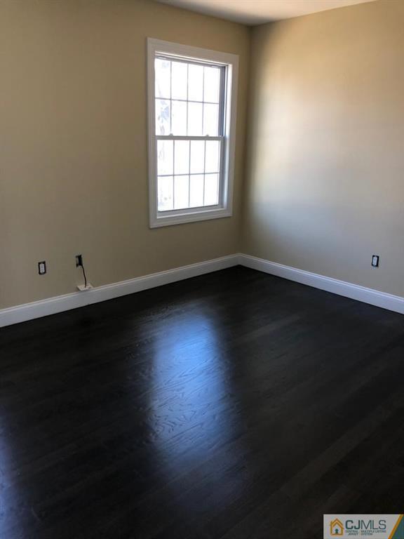 42 Crescent Road Edison, NJ 08817 - Photo 9 of 20 an empty room with wooden floor and windows