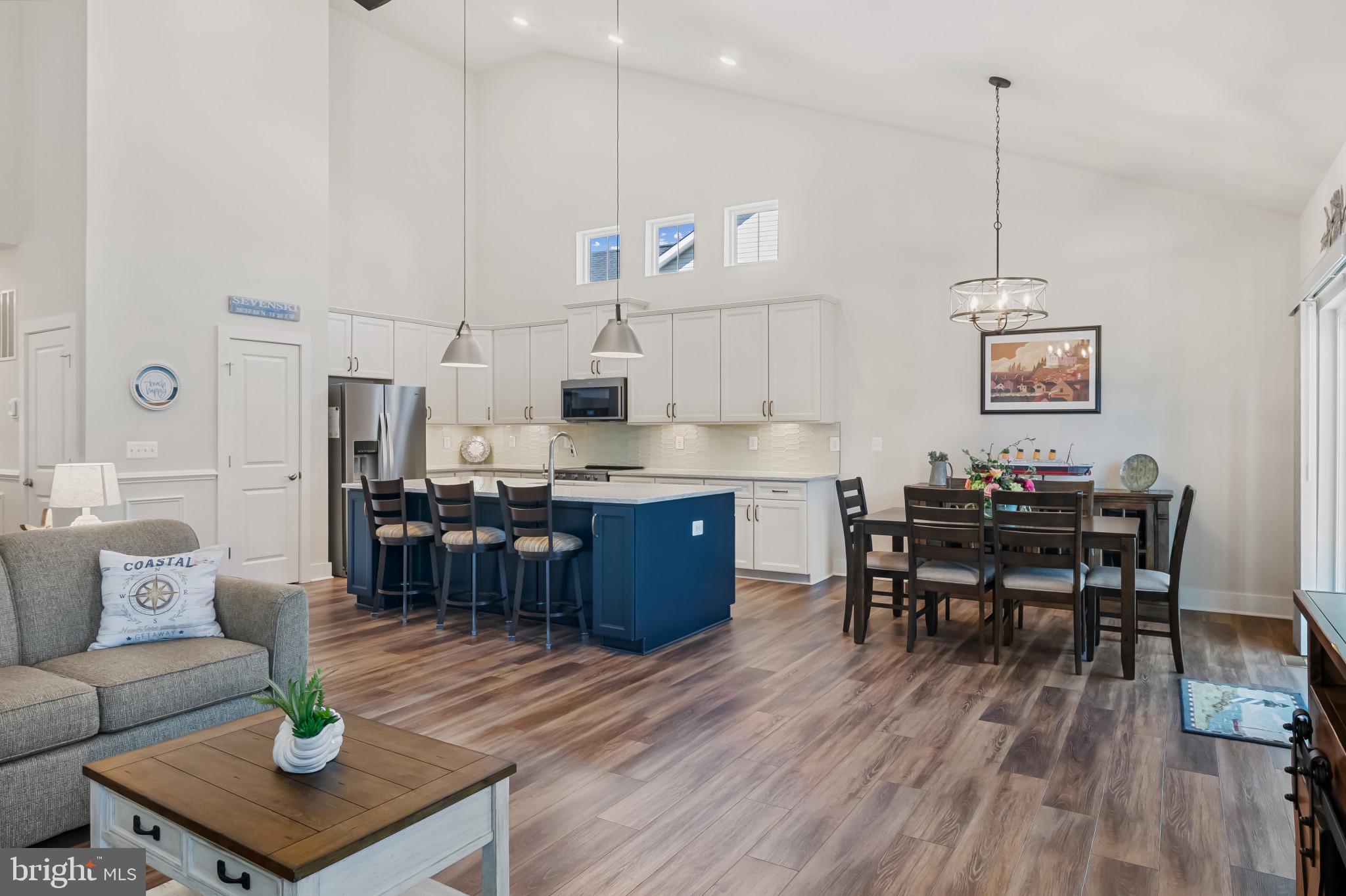 19437 Longfellow Way Georgetown, DE 19947 - Photo 13 of 33 a living room with furniture and a dining table with kitchen view