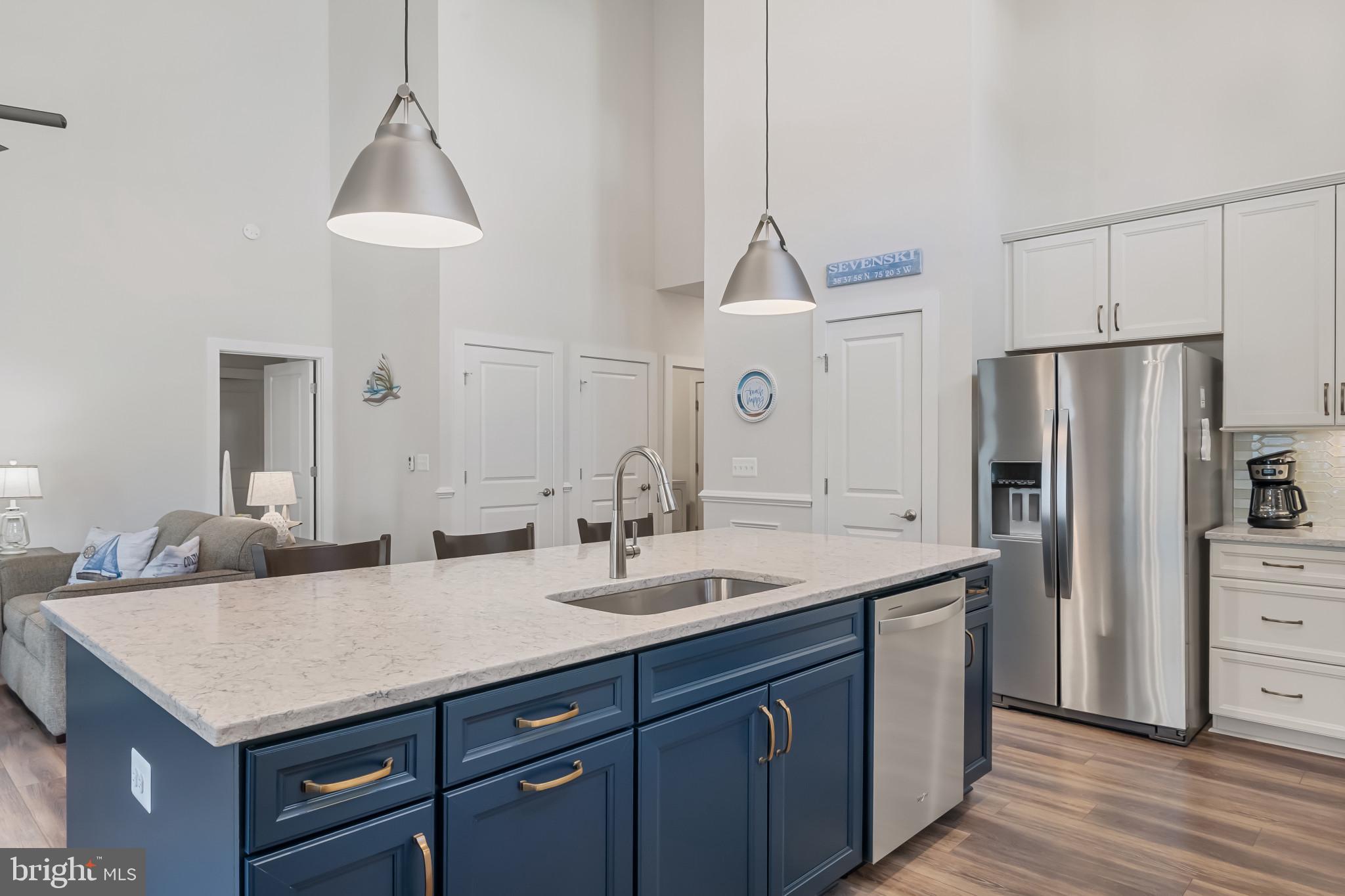 19437 Longfellow Way Georgetown, DE 19947 - Photo 19 of 33 a kitchen with granite countertop a sink cabinets and stainless steel appliances