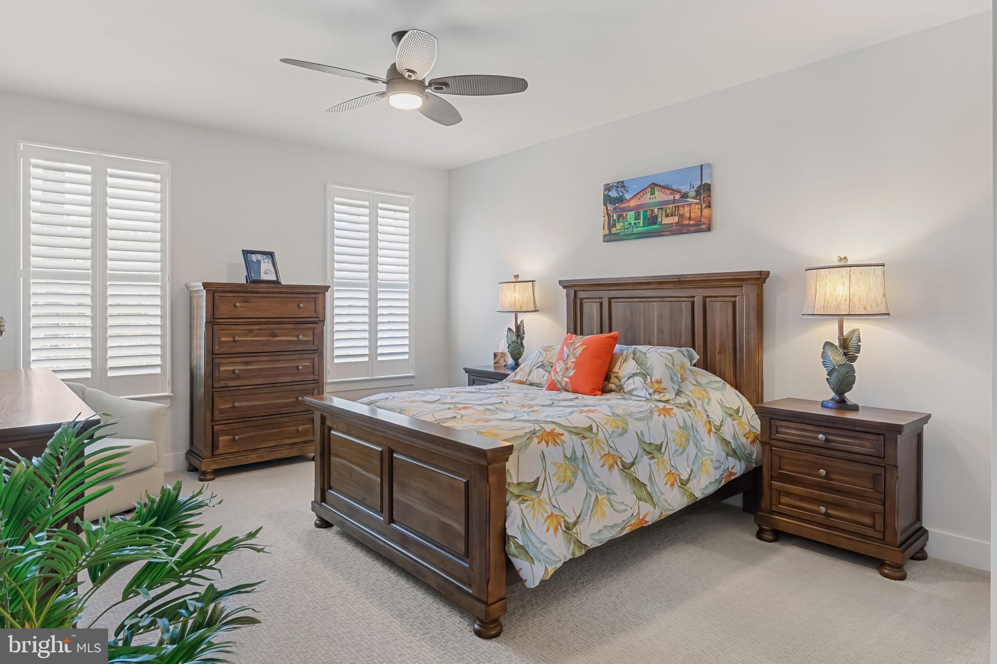 19437 Longfellow Way Georgetown, DE 19947 - Photo 24 of 33 a bedroom with a bed and a chandelier