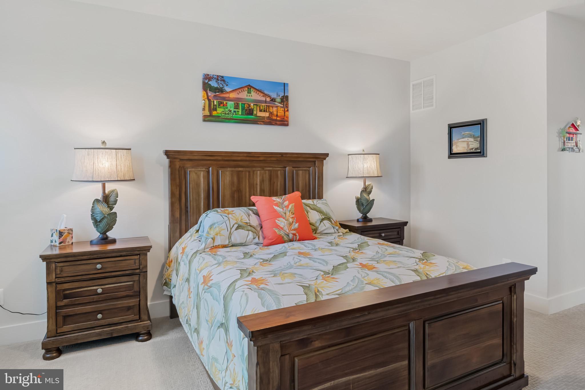 19437 Longfellow Way Georgetown, DE 19947 - Photo 25 of 33 a bedroom with a bed and a lamp on dresser