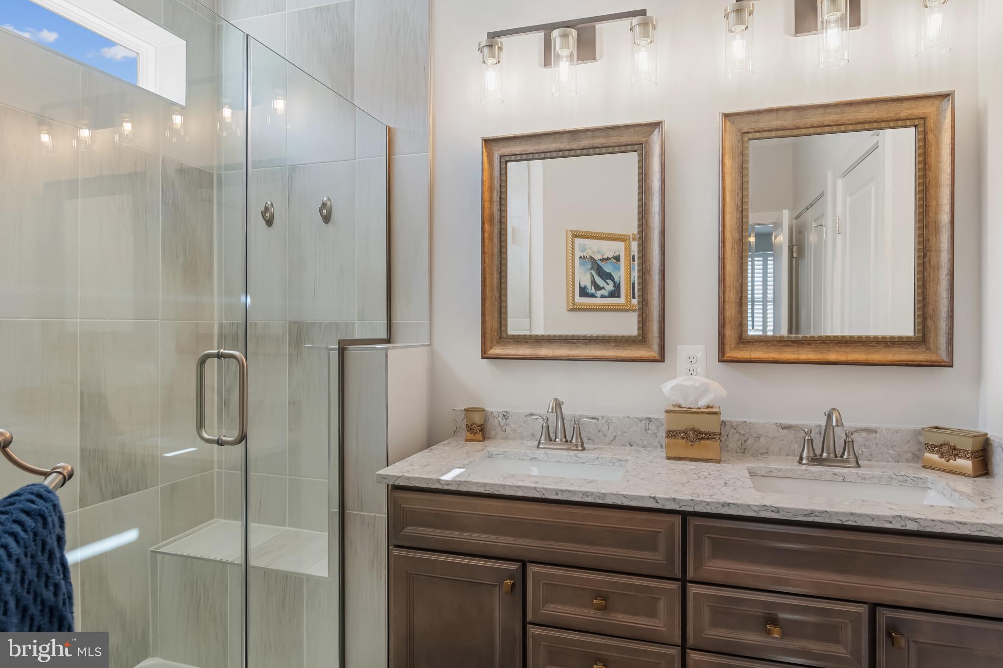 19437 Longfellow Way Georgetown, DE 19947 - Photo 28 of 33 a bathroom with a granite countertop sink mirror and double